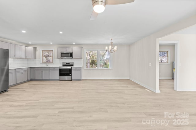 174 Maske Rd, Mount Gilead, NC 27306 - kitchen featuring gray cabinets, stainless steel appliances, a chandelier, healthy amount of natural light, and recessed lighting