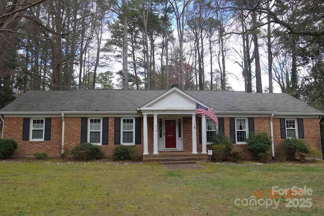 910 Parham St, Henderson, NC 27536 - neoclassical / greek revival house with brick siding and a front yard