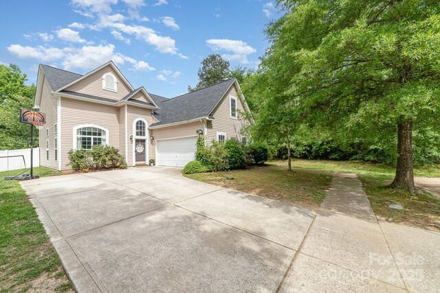 8927 Comstock Ct, Locust, NC 28097 - traditional-style house with driveway, an attached garage, and a shingled roof