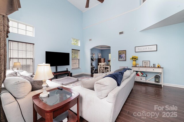 8927 Comstock Ct, Locust, NC 28097 - living room with arched walkways, high vaulted ceiling, baseboards, a ceiling fan, and dark wood finished floors