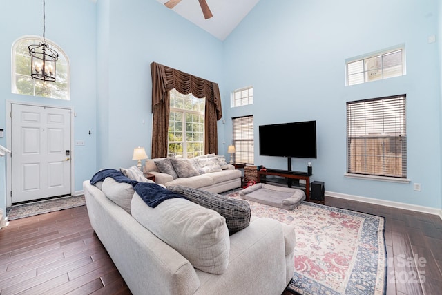 8927 Comstock Ct, Locust, NC 28097 - living room featuring high vaulted ceiling, dark wood-type flooring, ceiling fan, baseboards, and a chandelier