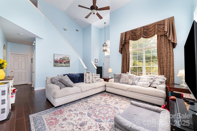 8927 Comstock Ct, Locust, NC 28097 - living room with ceiling fan, dark wood-style floors, high vaulted ceiling, and baseboards