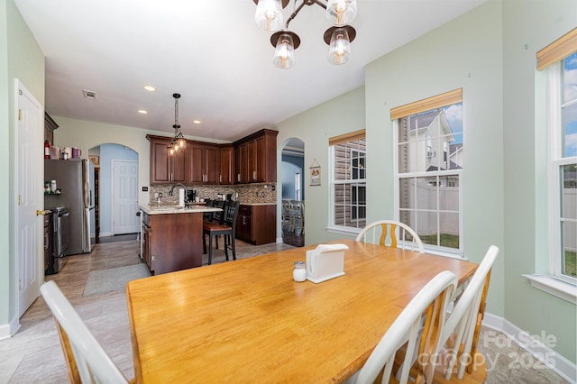 8927 Comstock Ct, Locust, NC 28097 - dining area with arched walkways, a chandelier, plenty of natural light, and recessed lighting