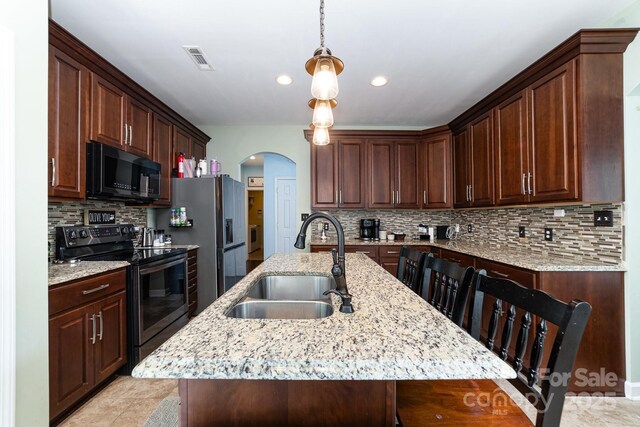 8927 Comstock Ct, Locust, NC 28097 - kitchen featuring black microwave, electric range oven, a sink, arched walkways, and stainless steel fridge with ice dispenser