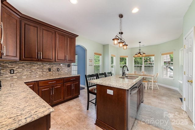 8927 Comstock Ct, Locust, NC 28097 - kitchen with a sink, decorative backsplash, arched walkways, baseboards, and recessed lighting