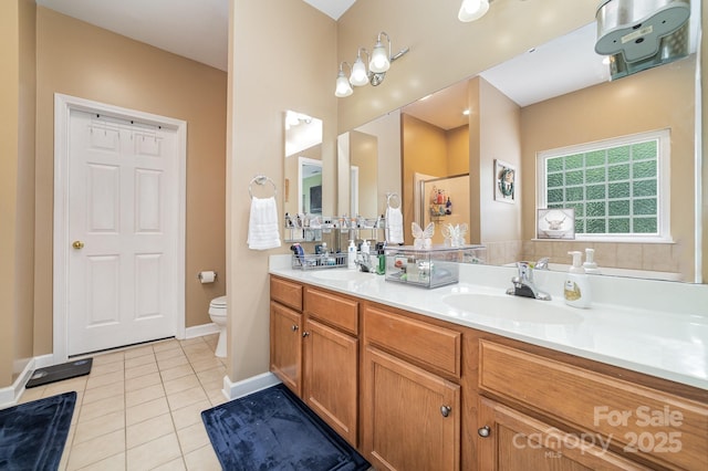 8927 Comstock Ct, Locust, NC 28097 - bathroom with tile patterned floors, double vanity, toilet, and baseboards