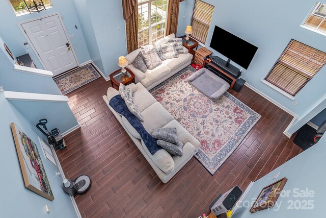 8927 Comstock Ct, Locust, NC 28097 - living room featuring wood finished floors, baseboards, and a chandelier