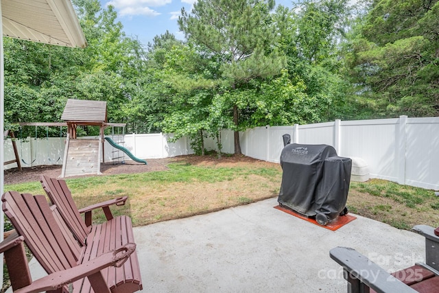8927 Comstock Ct, Locust, NC 28097 - fenced backyard with a patio, a playground, and a grill