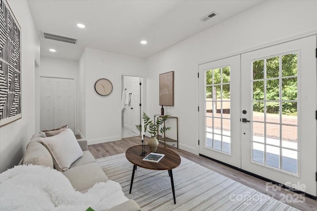 1015 4th St, Spencer, NC 28159 - living area with french doors, wood finished floors, baseboards, and recessed lighting