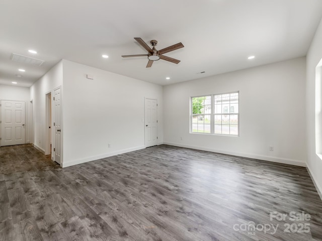 spare room featuring ceiling fan, recessed lighting, wood finished floors, and baseboards