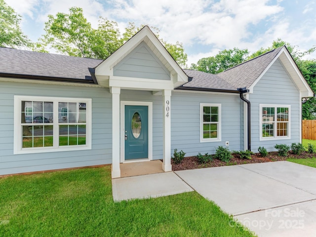 single story home with roof with shingles