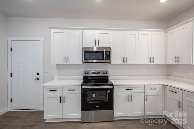 1941 32nd St NE, Hickory, NC 28601 - kitchen with appliances with stainless steel finishes, dark wood-type flooring, white cabinets, and light countertops