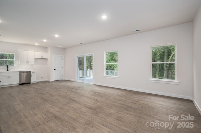 1941 32nd St NE, Hickory, NC 28601 - unfurnished living room with plenty of natural light, recessed lighting, a sink, wood finished floors, and baseboards