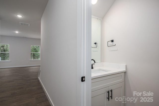 1941 32nd St NE, Hickory, NC 28601 - bathroom with wood finished floors, vanity, baseboards, and recessed lighting
