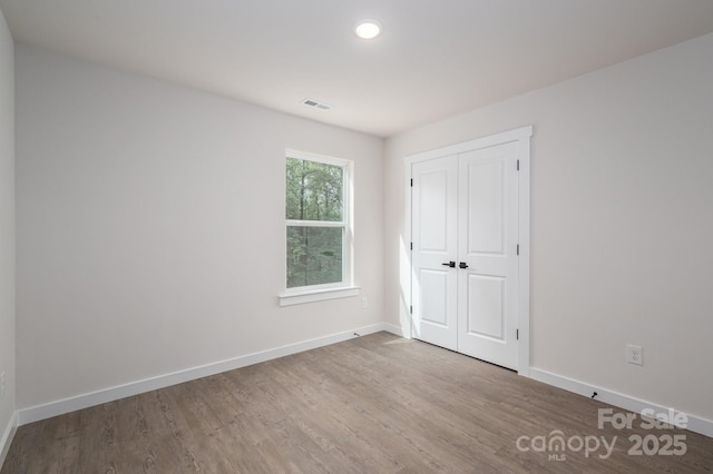 1941 32nd St NE, Hickory, NC 28601 - unfurnished bedroom featuring wood finished floors, baseboards, a closet, and recessed lighting