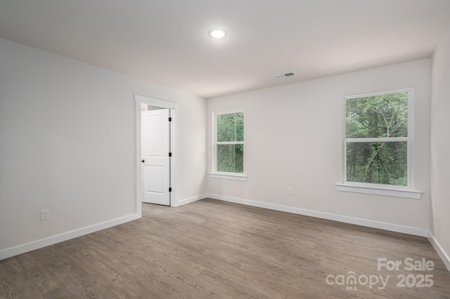 1941 32nd St NE, Hickory, NC 28601 - spare room featuring wood finished floors, healthy amount of natural light, and baseboards