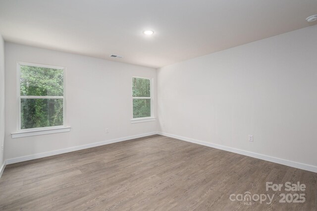 1941 32nd St NE, Hickory, NC 28601 - unfurnished room with wood finished floors, plenty of natural light, baseboards, recessed lighting, and a smoke detector
