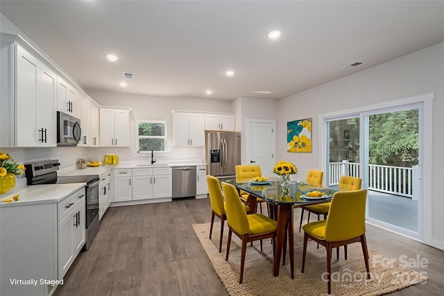 1941 32nd St NE, Hickory, NC 28601 - kitchen featuring appliances with stainless steel finishes, recessed lighting, dark wood-type flooring, and white cabinets
