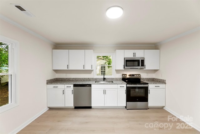 1155 Cedar Grove Ln, Rock Hill, SC 29732 - kitchen with stainless steel appliances, a sink, ornamental molding, white cabinets, and light stone counters