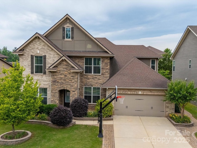 1190 Arges River Dr, Fort Mill, SC 29715 - view of front of house with an attached garage, stone siding, a front lawn, concrete driveway, and roof with shingles