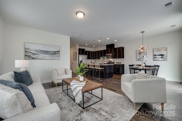 5836 Clan Maclaine Dr, Charlotte, NC 28278 - living room with baseboards, a chandelier, recessed lighting, and wood finished floors