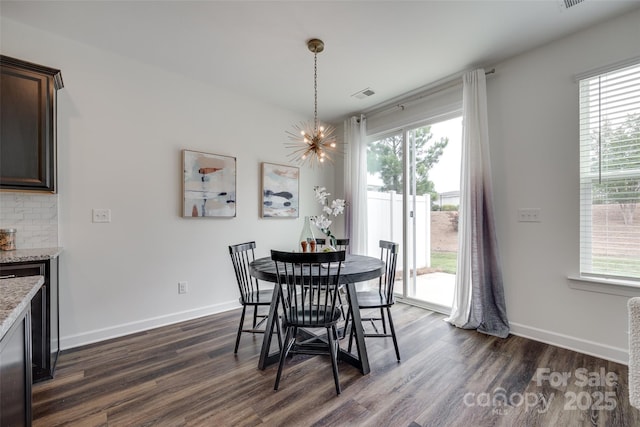5836 Clan Maclaine Dr, Charlotte, NC 28278 - dining room with a chandelier, dark wood-type flooring, and healthy amount of natural light