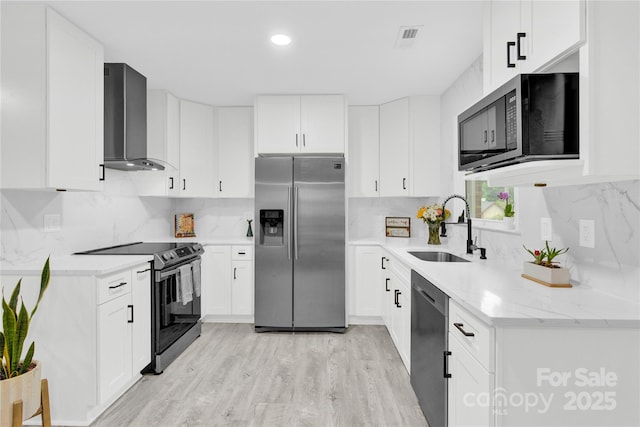 4108 Mellon Rd, Matthews, NC 28104 - kitchen featuring stainless steel appliances, wall chimney range hood, a sink, tasteful backsplash, and recessed lighting