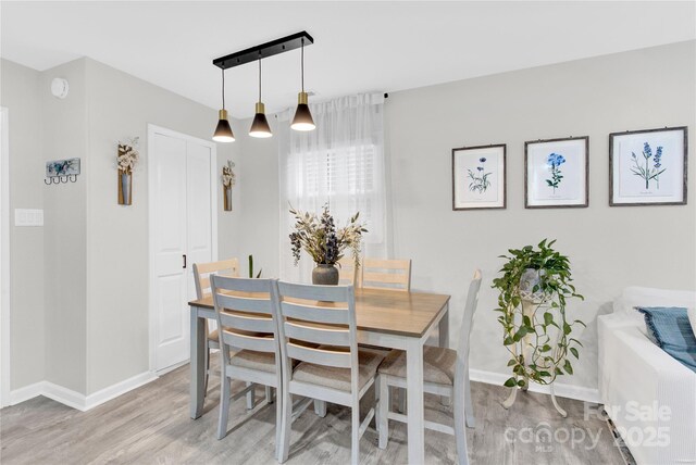 4108 Mellon Rd, Matthews, NC 28104 - dining space with a chandelier, light wood finished floors, and baseboards