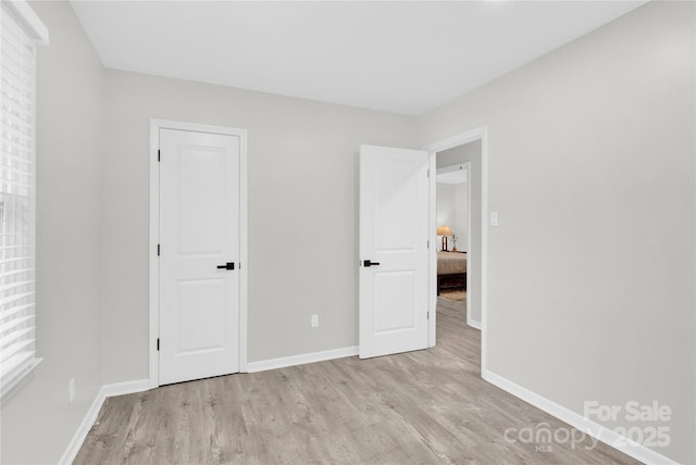 4108 Mellon Rd, Matthews, NC 28104 - unfurnished bedroom featuring light wood-style flooring and baseboards