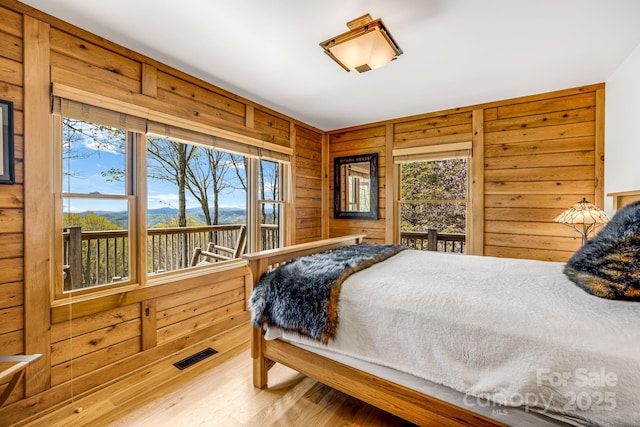 2399 El Miner Dr, Mars Hill, NC 28754 - bedroom featuring wood walls, wood finished floors, and a mountain view