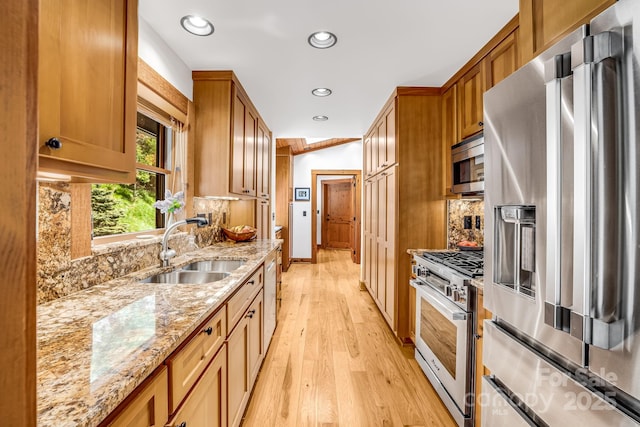 2399 El Miner Dr, Mars Hill, NC 28754 - kitchen with stainless steel appliances, light wood-style floors, decorative backsplash, recessed lighting, and brown cabinets