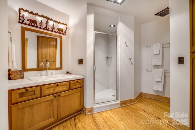 2399 El Miner Dr, Mars Hill, NC 28754 - bathroom with vanity, a stall shower, and wood finished floors