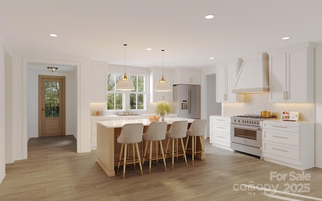 4995 Wildlife Ln Unit 1, Sherrills Ford, NC 28673 - kitchen with high quality appliances, premium range hood, decorative backsplash, light countertops, and recessed lighting