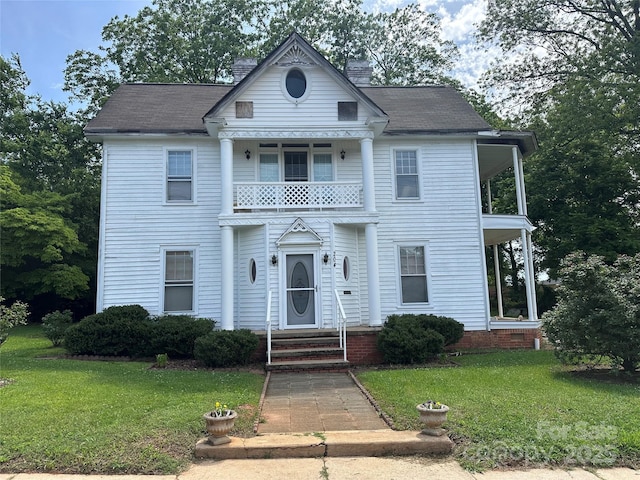 204 N Gaston St, Kings Mountain, NC 28086 - view of front of property featuring a balcony, a front lawn, and entry steps