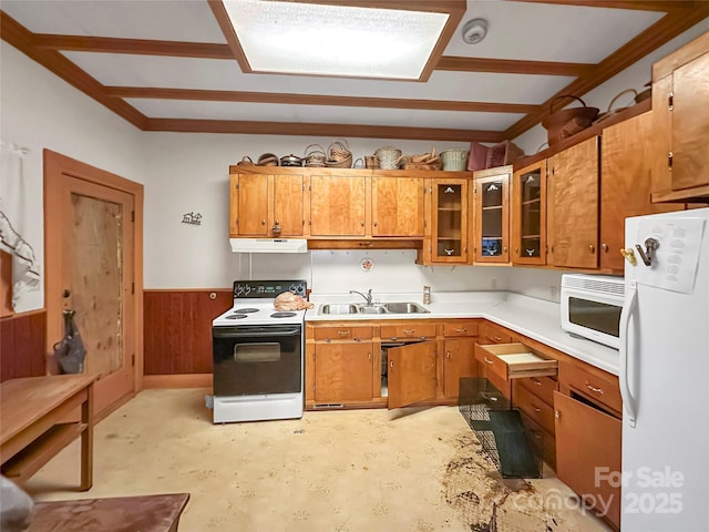 204 N Gaston St, Kings Mountain, NC 28086 - kitchen with white appliances, under cabinet range hood, a sink, brown cabinets, and wainscoting