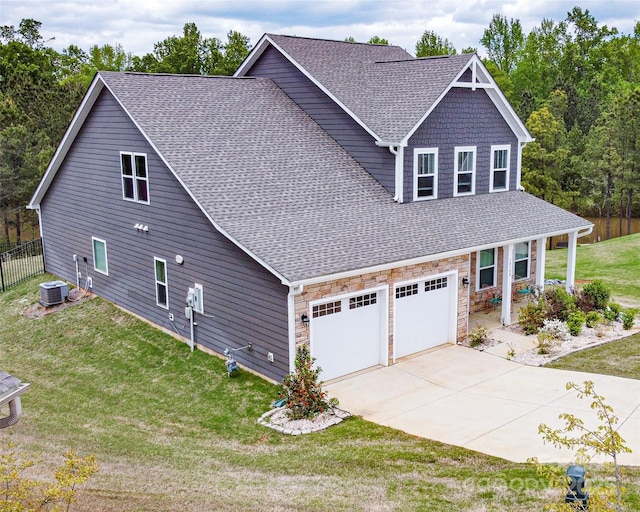 10100 Jack Nicklaus Dr, Lancaster, SC 29720 - view of side of home with roof with shingles, concrete driveway, covered porch, and stone siding