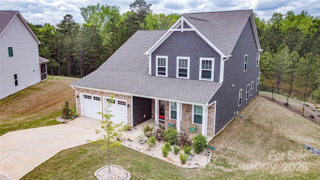 10100 Jack Nicklaus Dr, Lancaster, SC 29720 - view of front of property with driveway, stone siding, a shingled roof, a garage, and a wooded view