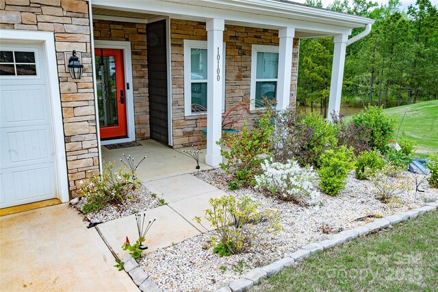 10100 Jack Nicklaus Dr, Lancaster, SC 29720 - doorway to property featuring stone siding and covered porch