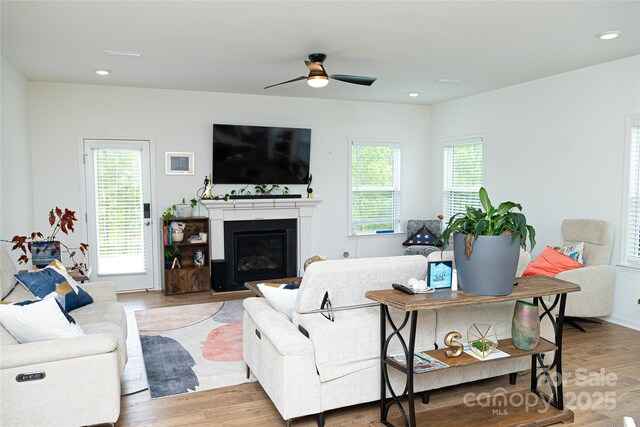 10100 Jack Nicklaus Dr, Lancaster, SC 29720 - living area featuring ceiling fan, light wood-type flooring, a glass covered fireplace, and recessed lighting