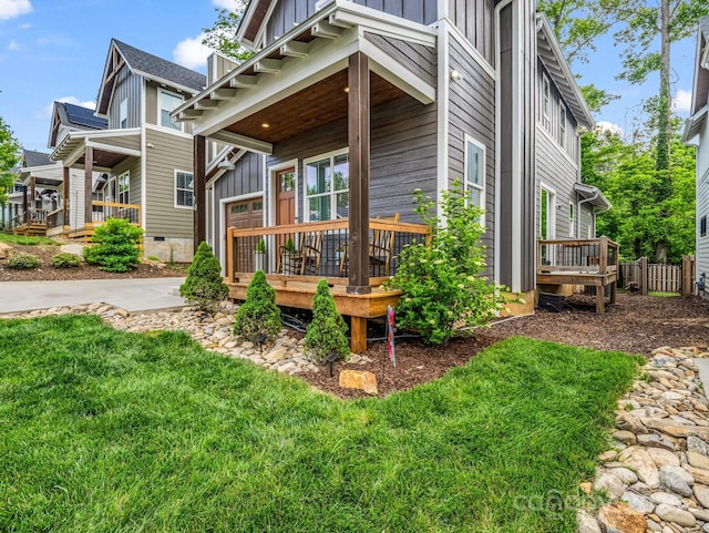 20 Phillip Ln, Arden, NC 28704 - view of side of property with board and batten siding, covered porch, and a yard