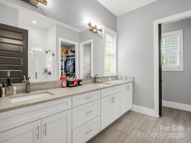 20 Phillip Ln, Arden, NC 28704 - full bathroom with a shower stall, a spacious closet, double vanity, and baseboards