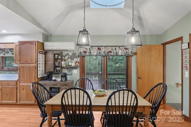 457 Shady Ridge Rd, Waynesville, NC 28785 - dining area featuring a wall unit AC, vaulted ceiling, and light wood-type flooring