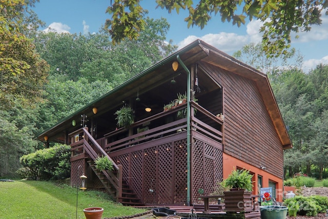 457 Shady Ridge Rd, Waynesville, NC 28785 - view of property exterior featuring a garage, stairway, a view of trees, and a yard