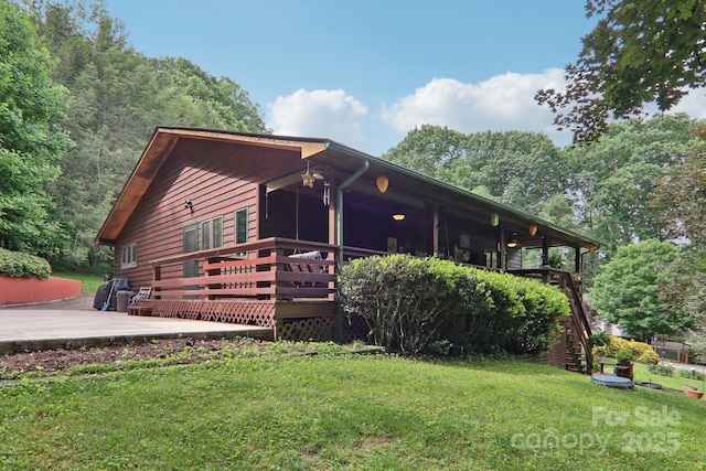 457 Shady Ridge Rd, Waynesville, NC 28785 - view of front of house featuring a front lawn, stairway, and a wooden deck