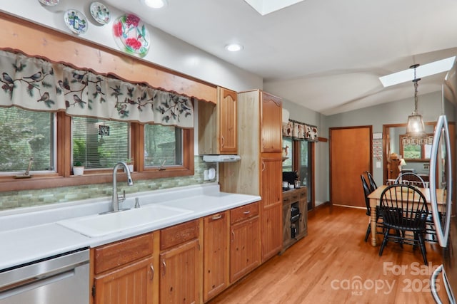 457 Shady Ridge Rd, Waynesville, NC 28785 - kitchen featuring a skylight, stainless steel dishwasher, lofted ceiling, light countertops, and light wood-type flooring