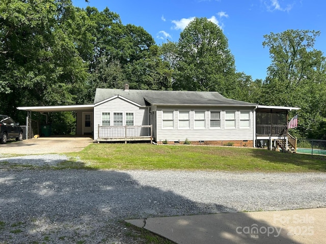 259 Oakland Heights Rd, Forest City, NC 28043 - view of front of house with crawl space, driveway, an attached carport, a sunroom, and a front yard