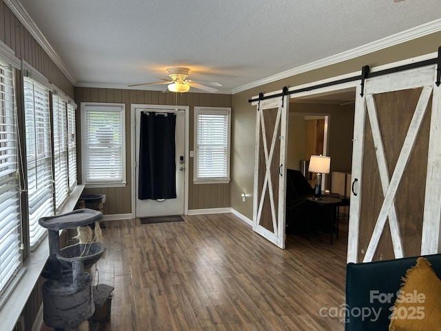 259 Oakland Heights Rd, Forest City, NC 28043 - entrance foyer with a barn door, a ceiling fan, wood finished floors, baseboards, and crown molding