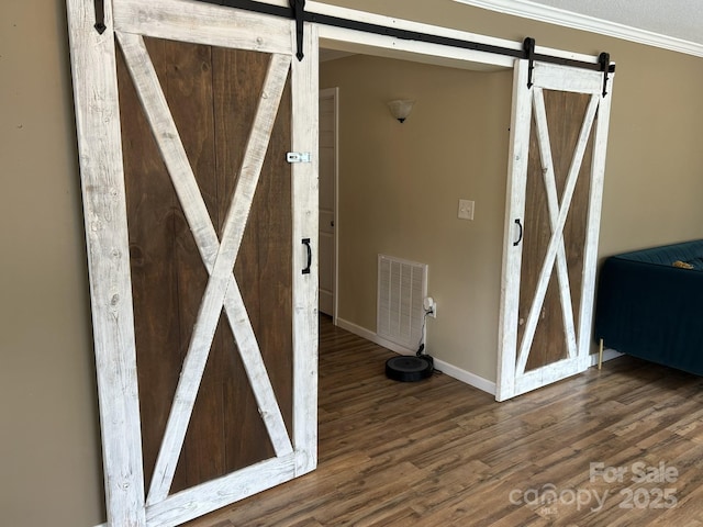 259 Oakland Heights Rd, Forest City, NC 28043 - detailed view of a barn door, wood finished floors, baseboards, and crown molding