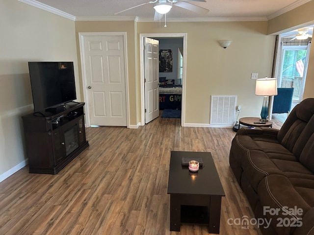259 Oakland Heights Rd, Forest City, NC 28043 - living room with a ceiling fan, wood finished floors, baseboards, and crown molding
