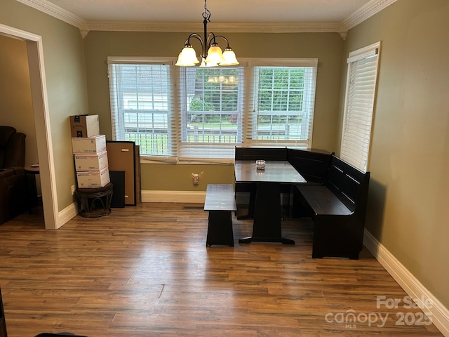 259 Oakland Heights Rd, Forest City, NC 28043 - dining room with a chandelier, crown molding, wood finished floors, breakfast area, and baseboards